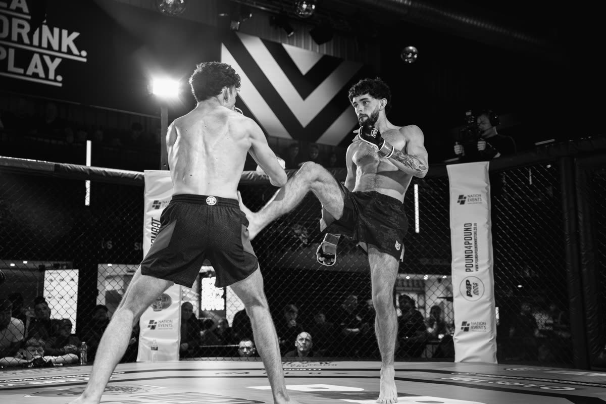 A kick being checked mid-fight in the cage
